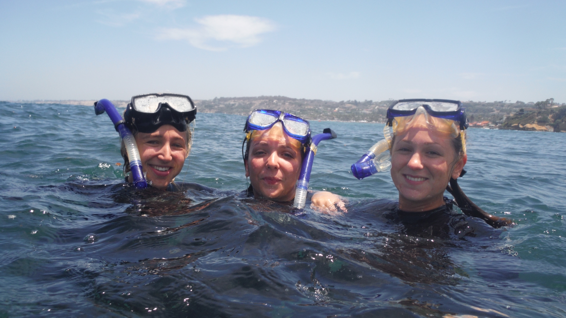 3 snorkelers in the water with mask up
